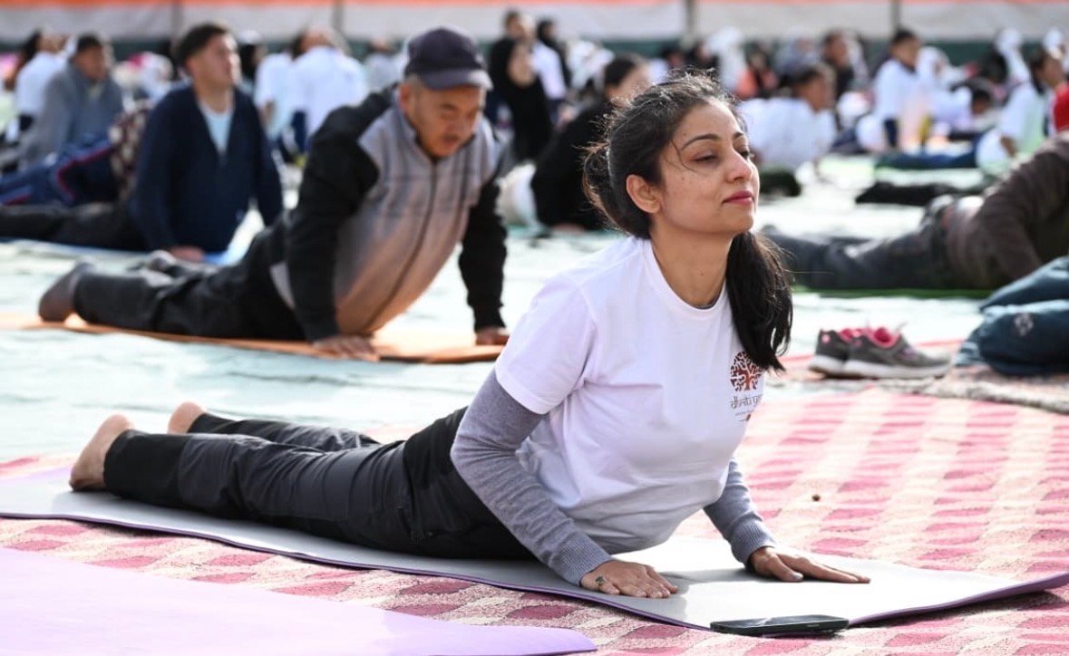 Outdoor yoga practice during a large community gathering